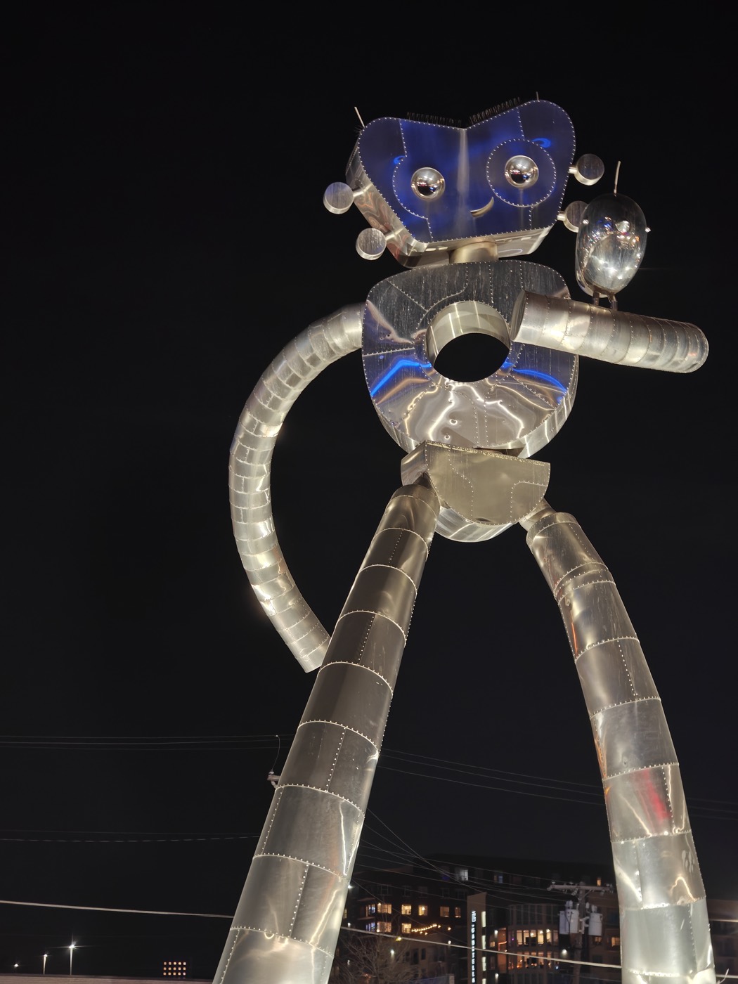 traveling man sculpture at night